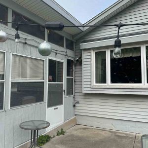 Before photo of an old three-season sunroom space in Brookfield prior to the Elite Home Renovations full-living addition.