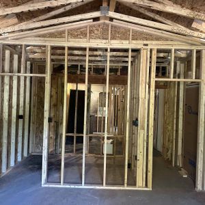 Under-construction framing of a vaulted ceiling addition showing professional structural engineering and timber work.