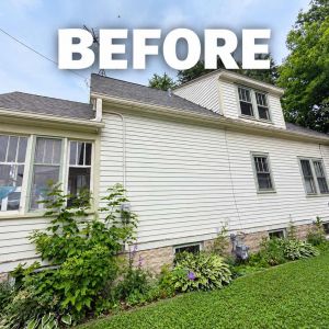 Before side view of home showing aged exterior siding and original window frames before renovation.   